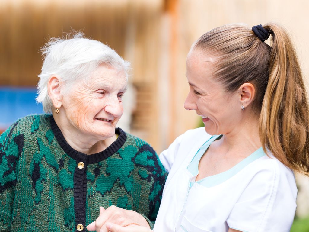caregiver-helping-discharged-elderly-woman 24 hour home care