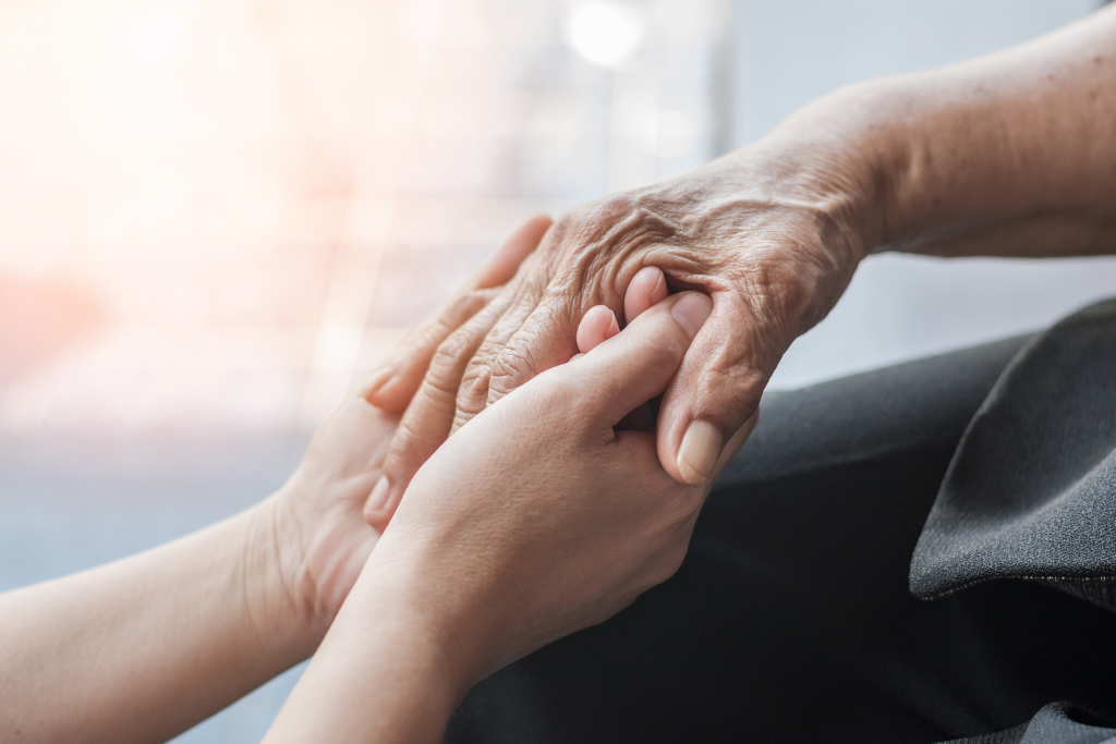 Younger hands holding older ones represent Companionship and Personal Care in Norwell, MA.