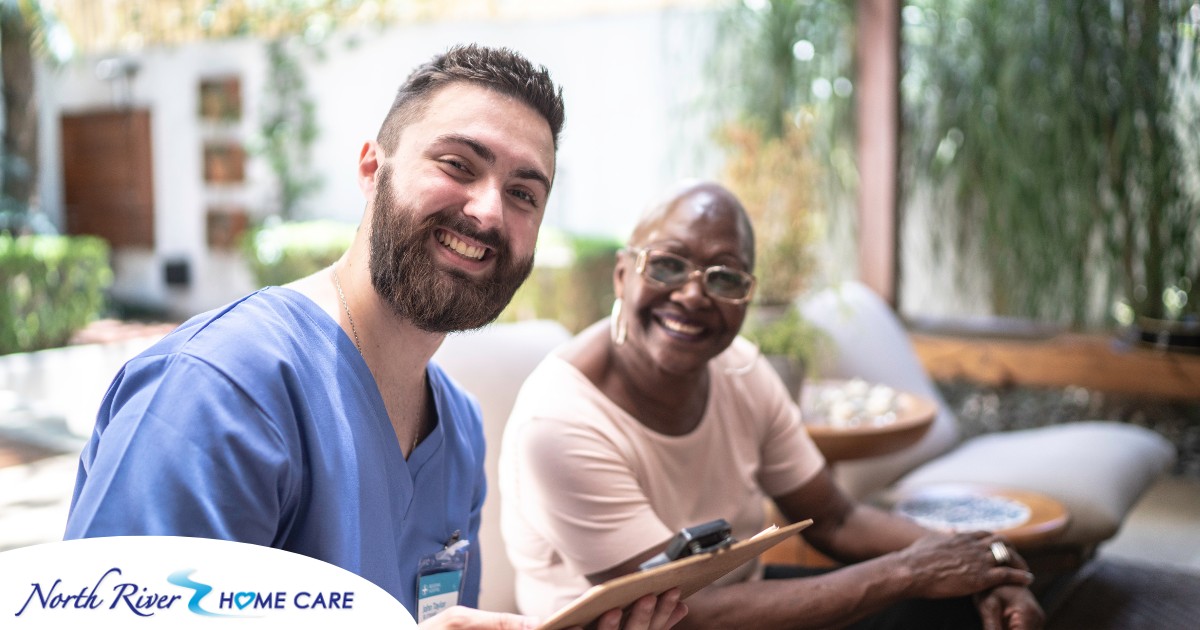 A man enjoys his caregiver job as he works with a client.