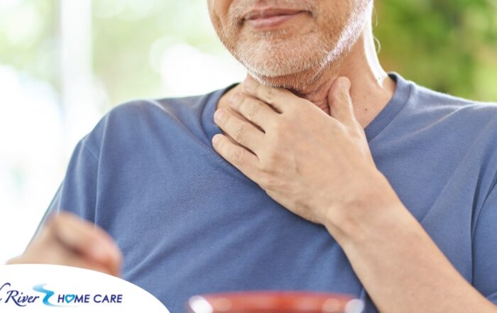 An older adult holds his throat representing dysphagia which can affect senior health.