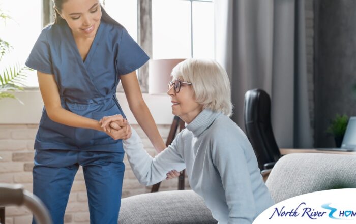 A caregiver demonstrates her caregiver skills by helping an older adult get up.