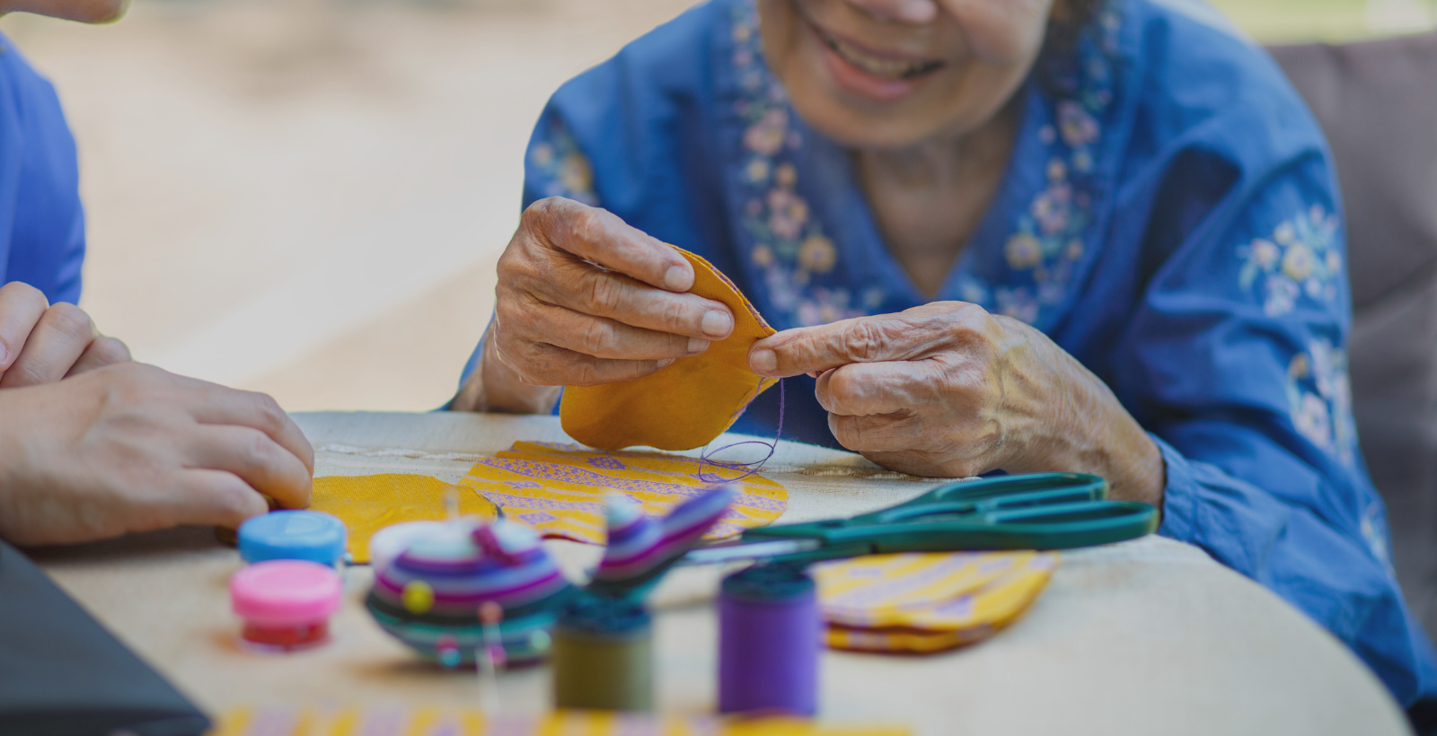 elderly person doing a puzzle with home health aide