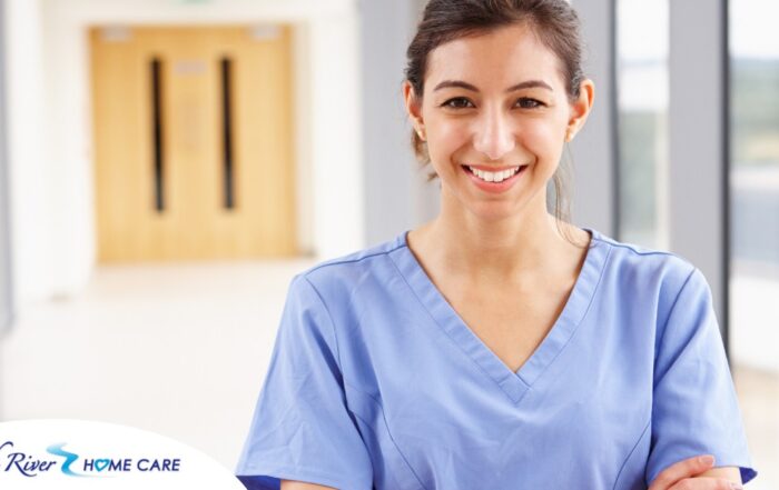 A woman in scrubs smiles, representing the good results that can come when caregivers branch out to become CNAs.