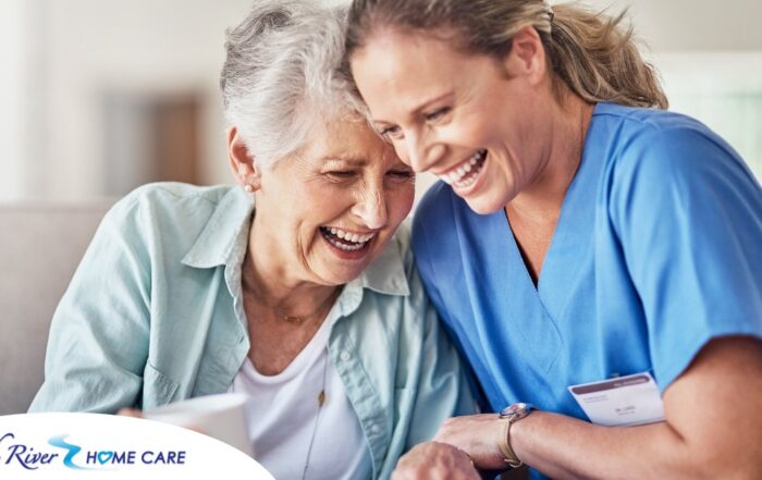 A woman in scrubs laughs with a senior woman, representing how caregiving can be a great career choice.